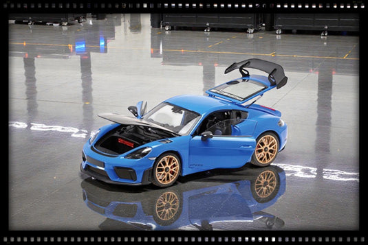 Porsche CAYMAN GT4 RS 2024 BLEU MÉTALLIQUE / ROUES DORÉES AVEC PACK WEISSACH MINICHAMPS 1:18
